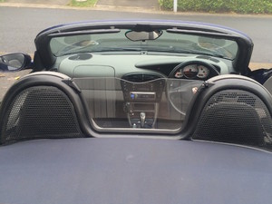 Facelift side repeater lenses and wind deflector on Porsche Boxster 986.